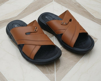 Pair of brown sandals with black soles on a patterned floor.